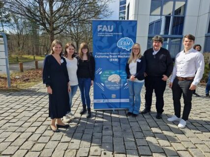 Prof. Boccaccini standing with Institute members and guests next to the project's banner