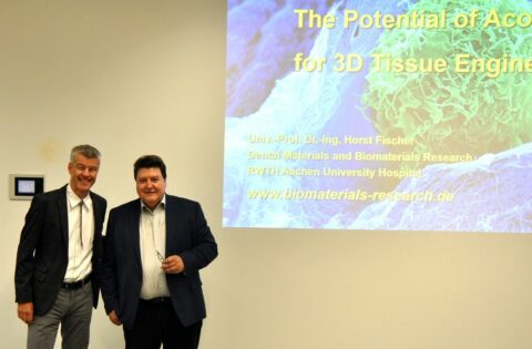 Prof. Fisher and Prof. Boccaccini standing in the lecture hall in front of the presentation