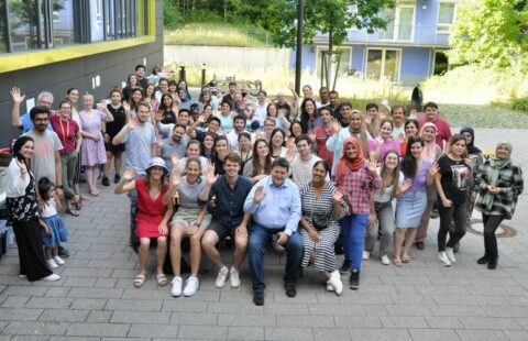 All of the Institute group sitting outside, facing the camera.