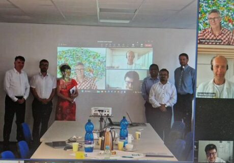 Dr. Boccaccini, Susanta, and the rest of the comittee standing in front of a wall with the Zoom meeting projected behind them.