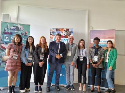 Prof. Boccaccini and the WW7 members standing by the conference sign.