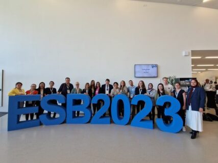 The members of the institute standing behind a blue ESB 2023 sign.