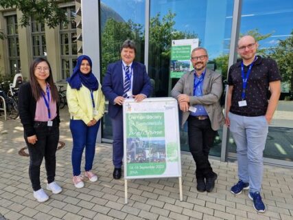 Prof. Boccaccini and other institute members standing by the conference sign.