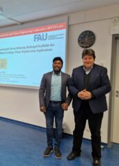 Prof. Boccaccini and Dr. Dey standing next to his presentation.