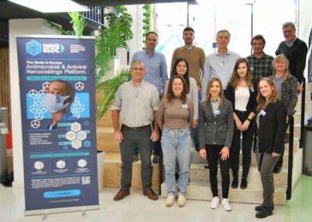 The project representatives standing next to the project's banner.