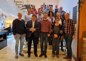 The WW professors standing in a group, looking at the camera.