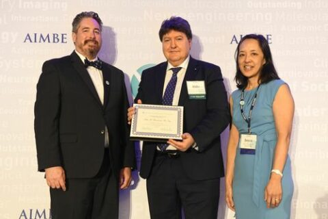 Prof. Boccaccini standing between two people, holding the award certificate.