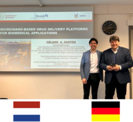 Prof. Boccaccini and Prof. Santos standing in front of the first slides of Prof. Santos presentation