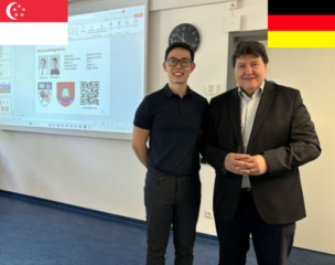 Prof. Boccaccini with Dr. Tay in front of his presentation smiling.