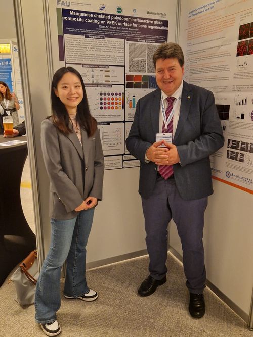 Prof. Boccaccini with PhD. student Zhiyan in the front of the poster